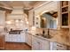 Gourmet kitchen featuring custom white cabinetry, granite countertops, stainless steel appliances, and a stylish backsplash at 595 Legacy Falls N Dr, Chapel Hill, NC 27517
