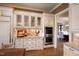 Elegant kitchen featuring custom white cabinetry, granite countertops, stainless steel appliances, and hardwood flooring at 595 Legacy Falls N Dr, Chapel Hill, NC 27517