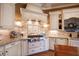 Gourmet kitchen featuring custom white cabinetry, granite countertops, stainless steel appliances, and stylish backsplash at 595 Legacy Falls N Dr, Chapel Hill, NC 27517