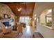 Bright living room featuring stone fireplace, hardwood floors, and French doors to outdoor space at 595 Legacy Falls N Dr, Chapel Hill, NC 27517