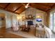 Inviting living room featuring a stone fireplace, hardwood floors, and custom built-in shelving at 595 Legacy Falls N Dr, Chapel Hill, NC 27517