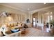 Inviting living room with a large sectional sofa, area rug, and distinctive wall decor, leading to an open layout at 595 Legacy Falls N Dr, Chapel Hill, NC 27517