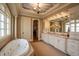 Elegant main bathroom with double vanity, soaking tub, and access to a walk-in closet at 595 Legacy Falls N Dr, Chapel Hill, NC 27517
