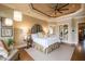 Luxurious main bedroom boasts tray ceilings, stylish furnishings, and a comfortable sitting area at 595 Legacy Falls N Dr, Chapel Hill, NC 27517