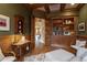 Stylish home office featuring custom built-in bookshelves, detailed wood trim, and natural light at 595 Legacy Falls N Dr, Chapel Hill, NC 27517