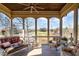 Covered porch with wood ceiling overlooking the lake and landscape at 595 Legacy Falls N Dr, Chapel Hill, NC 27517