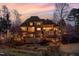 Expansive backyard view showcasing the home, covered patios, and beautiful landscaping at 595 Legacy Falls N Dr, Chapel Hill, NC 27517
