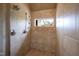 Tiled shower featuring a window, showerhead, and handheld wand at 595 Legacy Falls N Dr, Chapel Hill, NC 27517