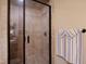 Tiled walk-in shower with glass door and a mounted showerhead, complemented by a towel rack at 595 Legacy Falls N Dr, Chapel Hill, NC 27517
