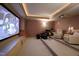 Relaxing home theater with comfortable seating, a large screen, and ambient lighting at 595 Legacy Falls N Dr, Chapel Hill, NC 27517