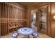 Wine room features stone floors, an intricate mosaic table, and ample wine storage at 595 Legacy Falls N Dr, Chapel Hill, NC 27517