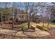 Landscaped backyard featuring lush greenery, a stone walkway, and mature trees at 595 Legacy Falls N Dr, Chapel Hill, NC 27517