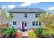 Inviting backyard featuring a patio dining set, lush landscaping, and a well-maintained lawn for outdoor enjoyment at 619 Ashburn Ln, Durham, NC 27703
