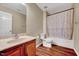 Bathroom featuring wooden floors, vanity, toilet and shower with a curtain at 619 Ashburn Ln, Durham, NC 27703