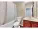 Bathroom with a shower-tub combo, vanity sink, and neutral colored walls and fixtures at 619 Ashburn Ln, Durham, NC 27703