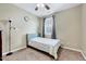 Cozy bedroom with neutral walls, carpet floors, a ceiling fan, and natural light from the window at 619 Ashburn Ln, Durham, NC 27703