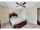 Bedroom featuring a wooden bed frame, carpet flooring, a ceiling fan and a closet at 619 Ashburn Ln, Durham, NC 27703