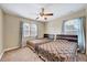Cozy bedroom featuring two twin beds, a ceiling fan, and natural light from the double windows at 619 Ashburn Ln, Durham, NC 27703
