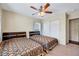 Bedroom featuring two twin beds, a ceiling fan, and a closet with sliding doors at 619 Ashburn Ln, Durham, NC 27703
