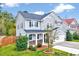 Well-maintained two-story home with landscaped front yard, stone accents, and attached garage at 619 Ashburn Ln, Durham, NC 27703