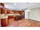 Well-equipped kitchen featuring wooden cabinets, granite countertops, and an island with bar seating at 619 Ashburn Ln, Durham, NC 27703