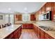 Bright kitchen with granite counters, stainless appliances, and center island with breakfast bar at 619 Ashburn Ln, Durham, NC 27703