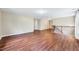 Open living room with hardwood floors, stairs to the second floor, and neutral paint at 619 Ashburn Ln, Durham, NC 27703