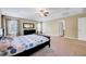 Spacious main bedroom with a tray ceiling, a ceiling fan, double windows, and a dresser at 619 Ashburn Ln, Durham, NC 27703