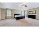 Spacious main bedroom with a tray ceiling, ceiling fan, double windows, and a dresser at 619 Ashburn Ln, Durham, NC 27703