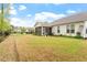 Spacious backyard with a screened porch, lush green grass, and established trees at 713 Catherine Lake Ct, Fuquay Varina, NC 27526