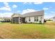 Expansive backyard featuring a screened porch, well-maintained lawn, and mature landscaping at 713 Catherine Lake Ct, Fuquay Varina, NC 27526