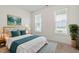 Comfortable bedroom with large windows, plush bedding, and stylish decor at 713 Catherine Lake Ct, Fuquay Varina, NC 27526