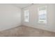 Bright, carpeted bedroom with two large windows allowing natural light at 713 Catherine Lake Ct, Fuquay Varina, NC 27526