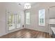 This eat-in-kitchen area is drenched in light from the many windows and glass doors to the backyard at 713 Catherine Lake Ct, Fuquay Varina, NC 27526