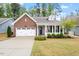 Charming single-story brick home featuring a well-manicured lawn and attached garage at 713 Catherine Lake Ct, Fuquay Varina, NC 27526