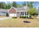 Well-maintained house with a brick accent, neat lawn, and attached two-car garage at 713 Catherine Lake Ct, Fuquay Varina, NC 27526