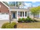 Inviting front porch with white columns, black shutters, and a vibrant blue front door at 713 Catherine Lake Ct, Fuquay Varina, NC 27526
