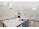 Kitchen with a spacious island countertop, stainless steel appliances, stylish pendants, and lots of natural light at 713 Catherine Lake Ct, Fuquay Varina, NC 27526