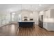 Open kitchen area featuring a blue island and stainless steel appliances at 713 Catherine Lake Ct, Fuquay Varina, NC 27526