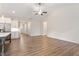 Open living area features hardwood flooring, kitchen, and a ceiling fan at 713 Catherine Lake Ct, Fuquay Varina, NC 27526