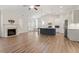 Bright, open living area with a fireplace, kitchen island, and hardwood floors at 713 Catherine Lake Ct, Fuquay Varina, NC 27526