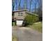 Exterior image showcasing the home's facade with an attached garage and well-maintained driveway amidst natural surroundings at 748 Currituck Dr, Raleigh, NC 27609