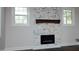 Close up of stone fireplace with dark mantle and electric insert at 808 Grace Ave, Burlington, NC 27217