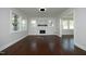 Bright living room with hardwood floors, stone accent fireplace, and abundant natural light at 808 Grace Ave, Burlington, NC 27217