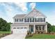 Charming two-story home featuring a two-car garage, manicured lawn, and classic architectural details at 809 Walker Ridge Way, Willow Springs, NC 27592