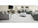 Comfortable living room boasts plush gray furniture and light colored carpet flooring at 809 Walker Ridge Way, Willow Springs, NC 27592