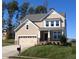 Charming two-story home featuring a craftsman-style design, attached garage, and well-manicured lawn, perfect for families at 810 Magnolia Acres Ln, Fuquay Varina, NC 27526