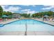 Large community pool with plenty of seating and a clear blue sky at 812 Canis Minor Rd, Wendell, NC 27591