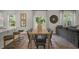 Open-concept dining area with wood table, seating for six, and view into the living room at 812 Canis Minor Rd, Wendell, NC 27591