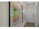 Bright entryway with wood flooring, framed artwork, and a white front door with glass inserts at 812 Canis Minor Rd, Wendell, NC 27591